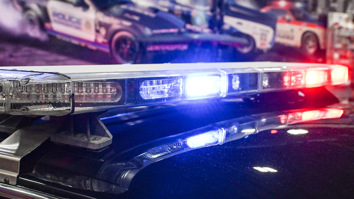 1993 Ford Mustang police vehicle with vintage emergency lights and sirens on display