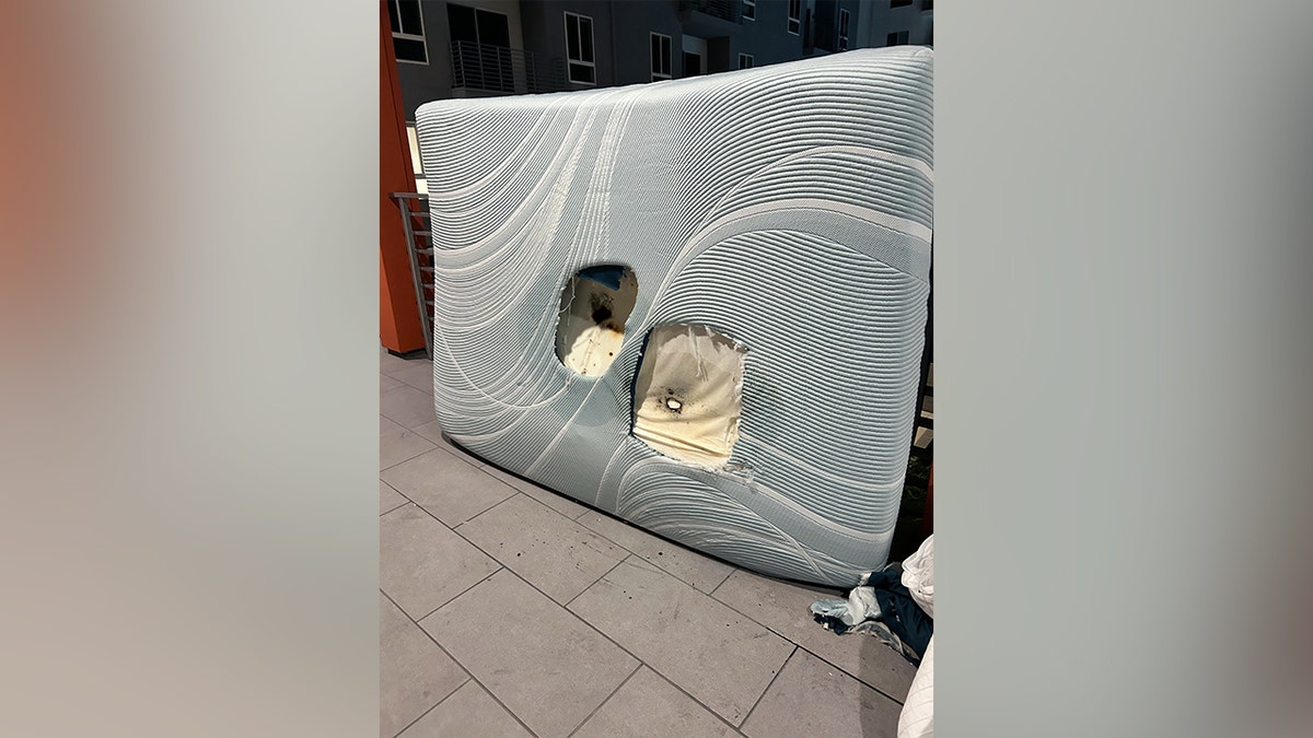 A damaged mattress after a portable phone charger exploded.