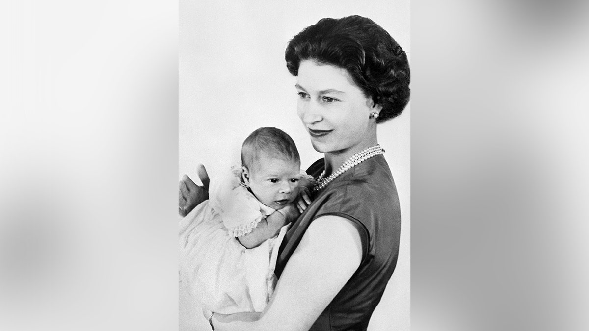 Queen Elizabeth holding a newborn Andrew Mountbatten-Windsor in March 1960.