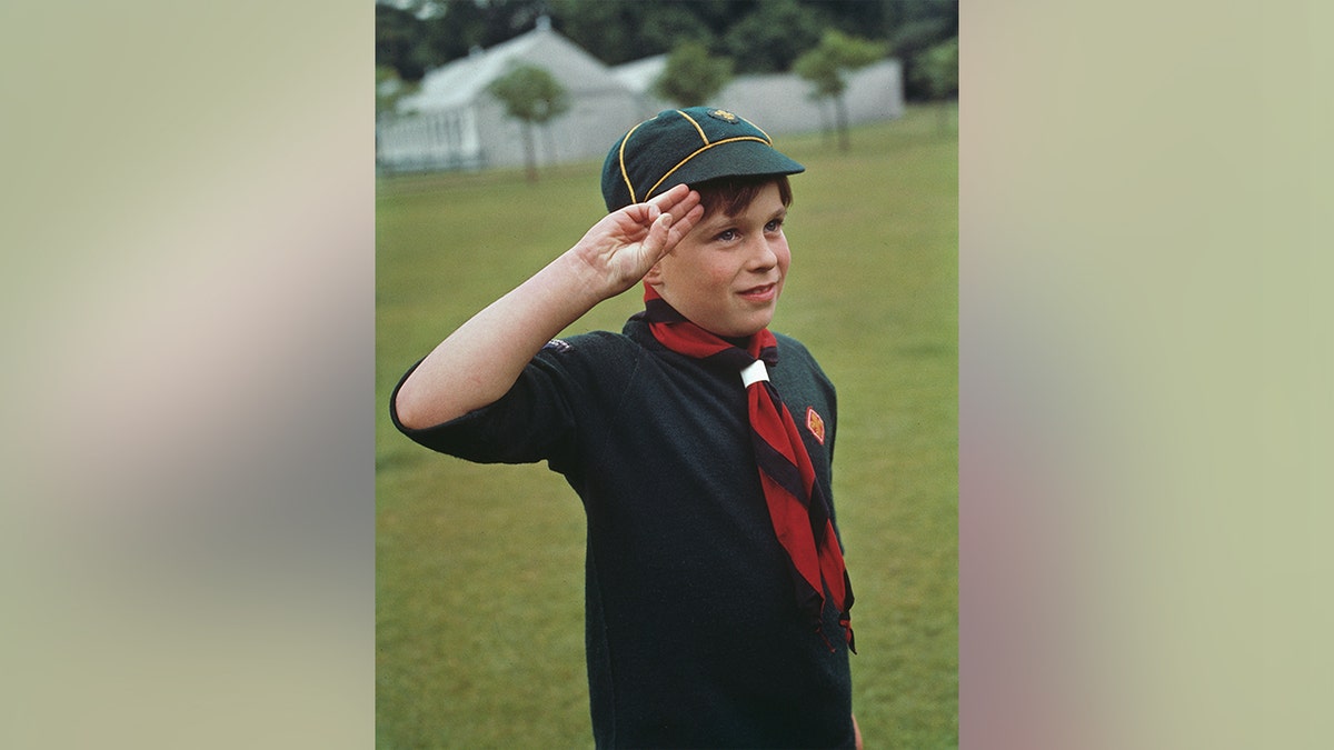 Prince Andrew saluting while dressed in his boy scouts uniform in 1968. 