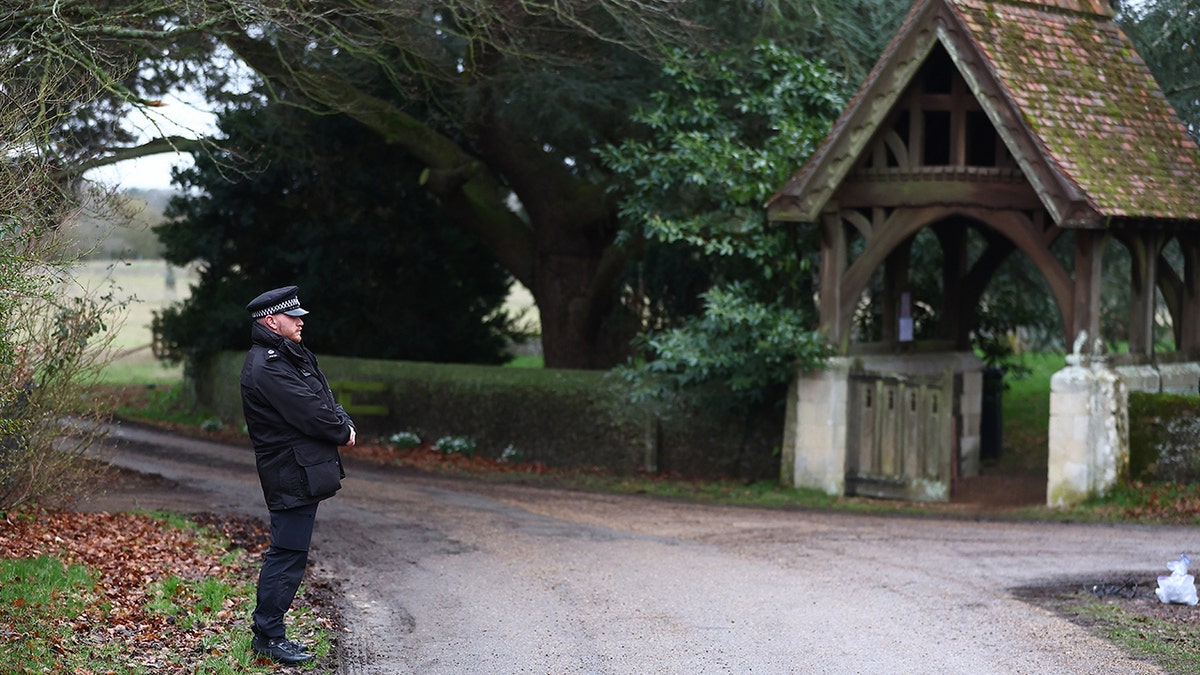 Police officers standing guard near the entrance to Andrew Mountbatten-Windsor's home.