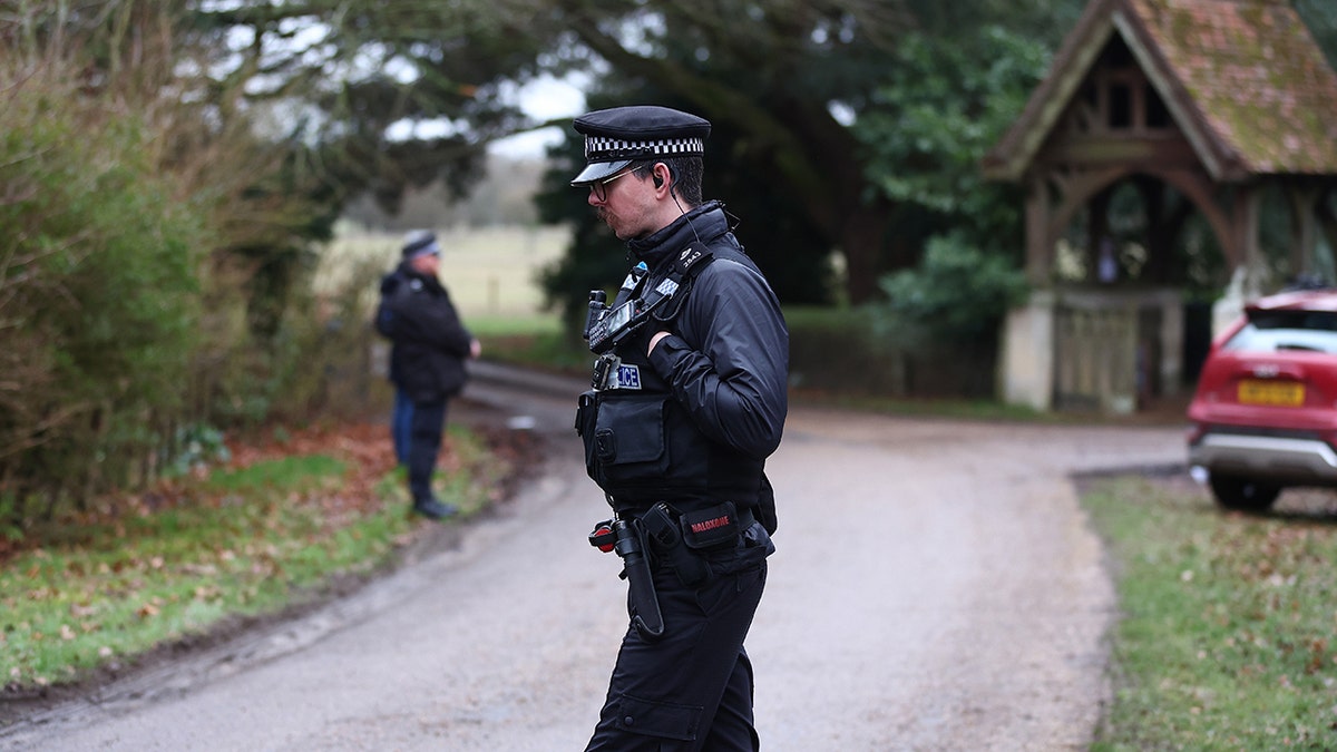 Police officers standing guard near the entrance to Andrew Mountbatten-Windsor's home.