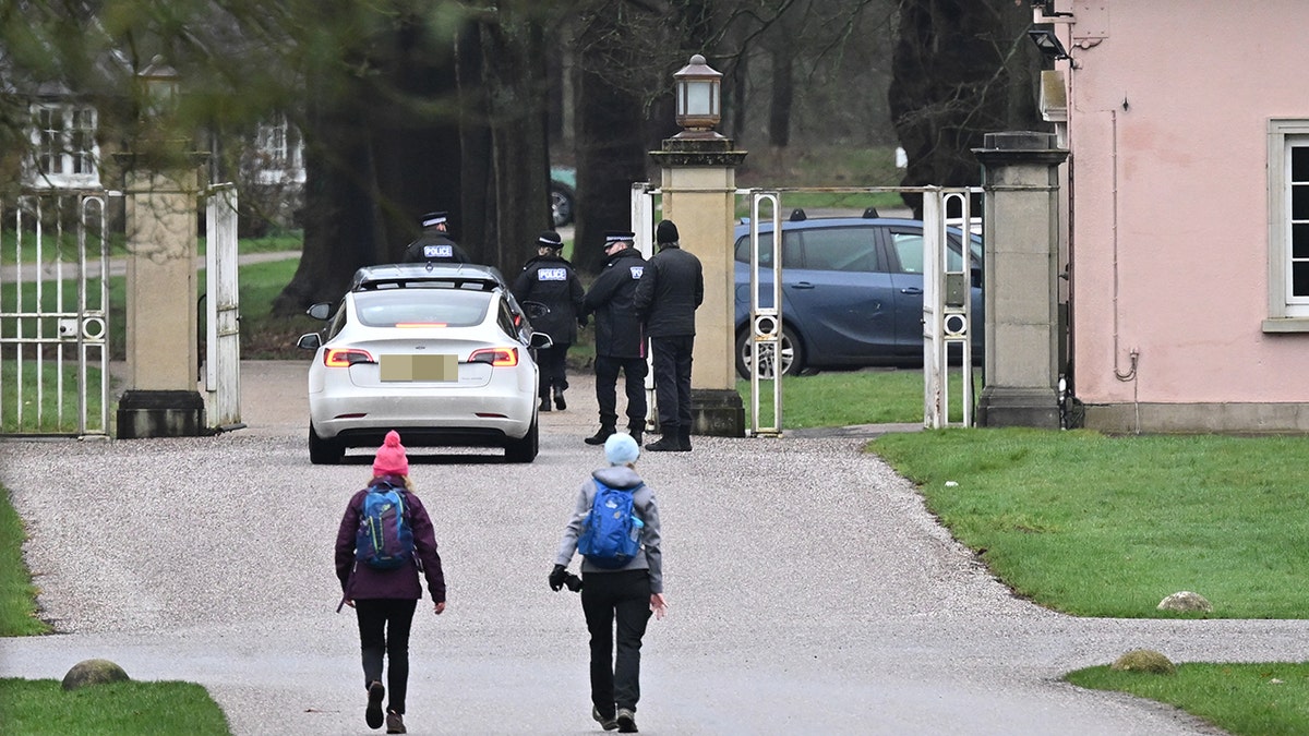 Vehicles entering the stone gates of Andrew Mountbatten-Windsor's former home at the Royal Lodge in Windsor Great Park.