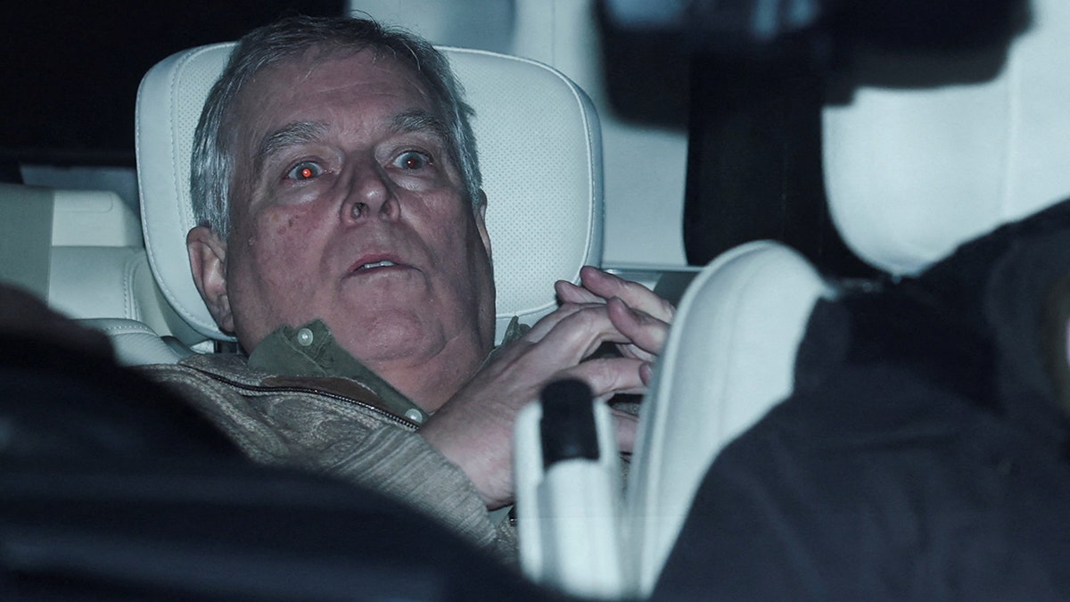 Andrew Mountbatten-Windsor seated in a vehicle while departing Aylsham Police Station.