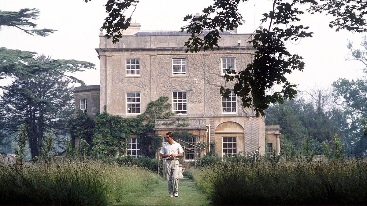 Prince Charles walking outside Highgrove House.