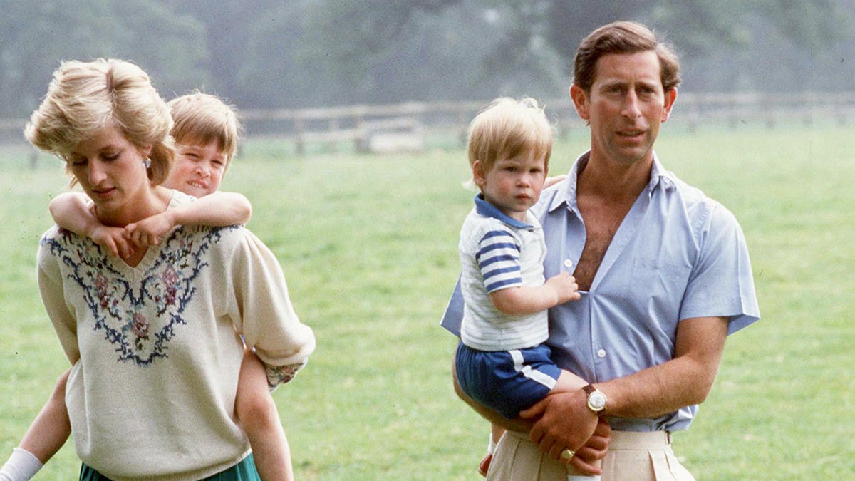 Prince Charles and Princess Diana holding their sons outside of Highgrove.