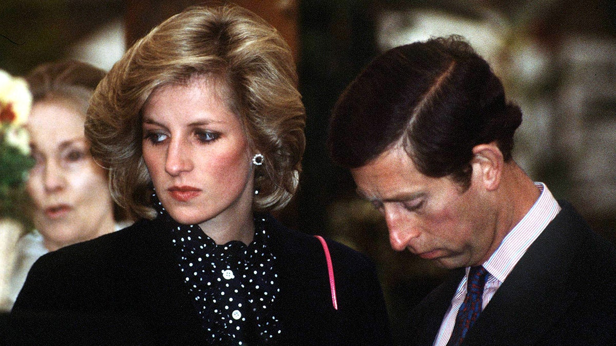 Princess Diana and King Charles looking glum in black.