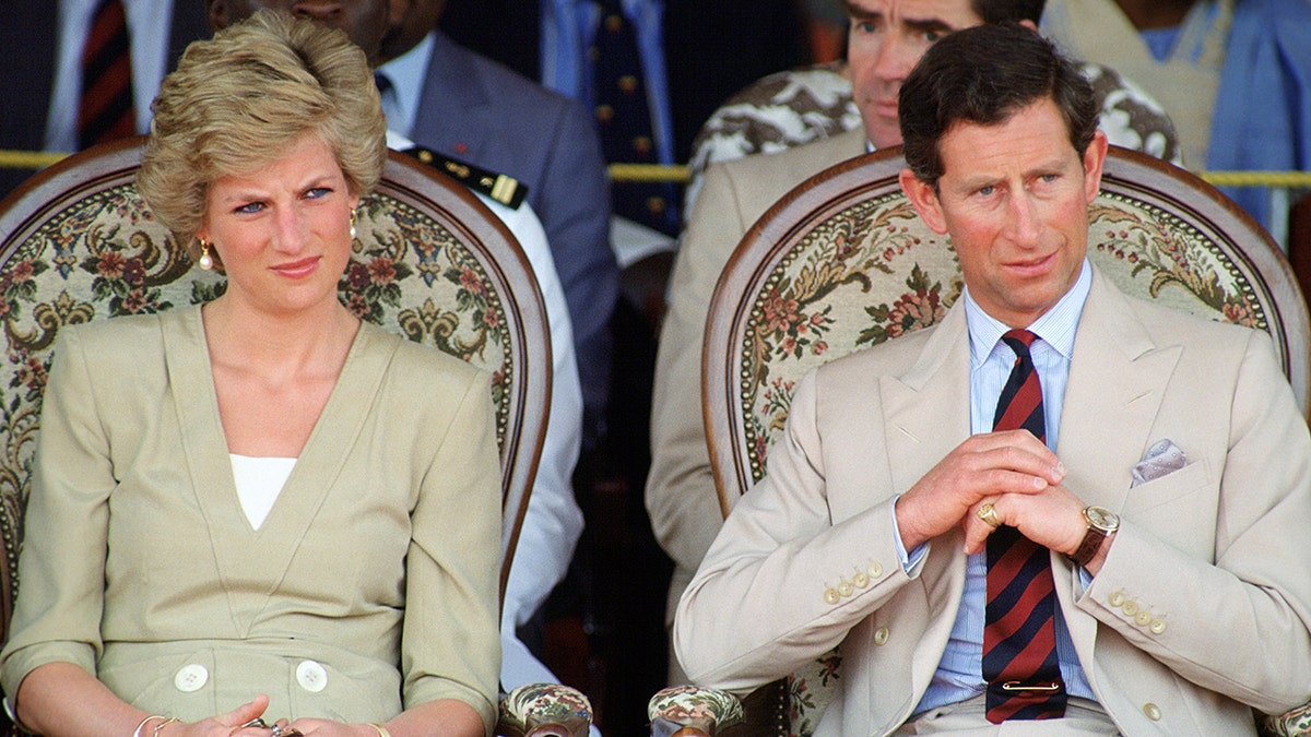 King Charles and Princess Diana wearing matching tanned suits outdoors.