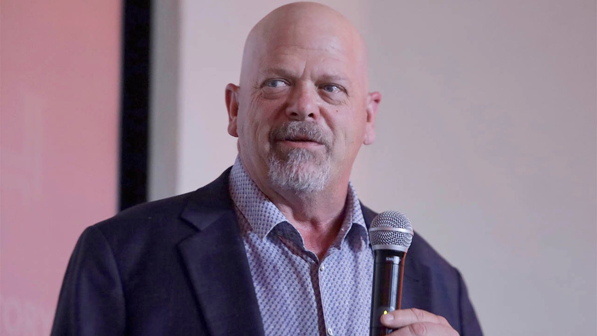 Rick Harrison holding a microphone