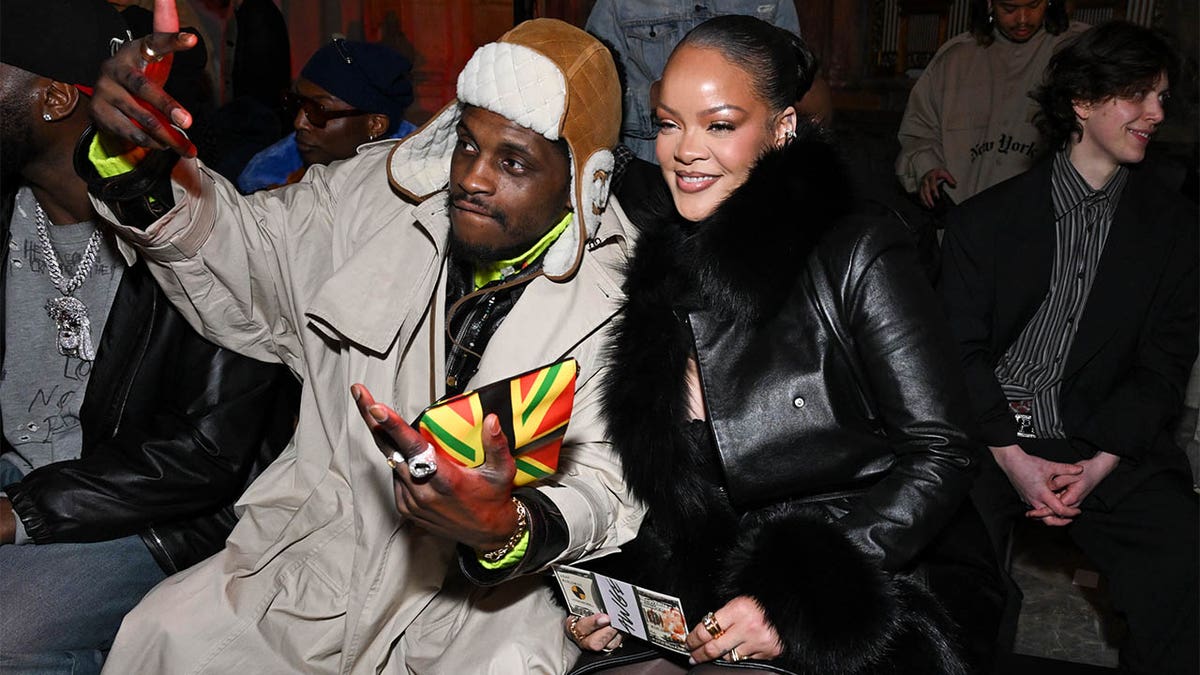 A$AP Nast and Rihanna watching Rocky's fashion show