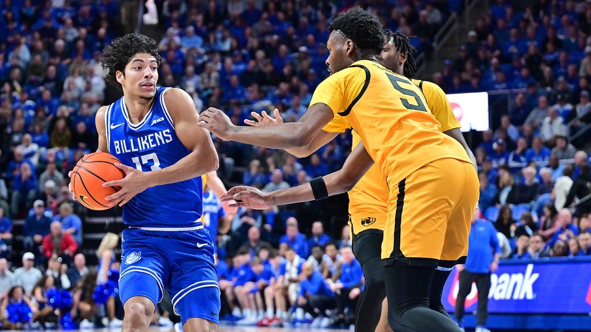 Saint Louis basketball player dribbles 