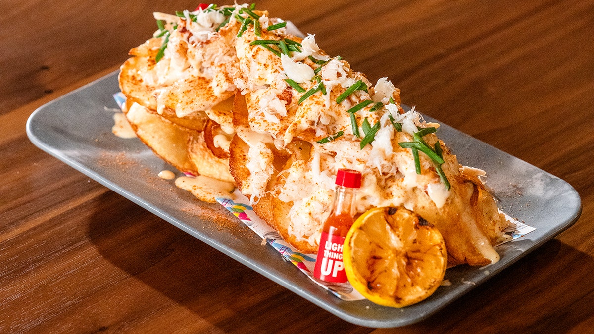 Dungeness Crab Potachos layer fresh local crab over potato chips with white cheddar fondue at Super Bowl LX.