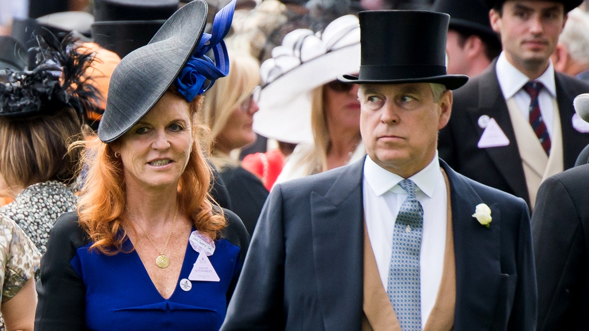 Sarah Ferguson and Prince Andrew, Duke of York standing together and smiling at a racecourse.