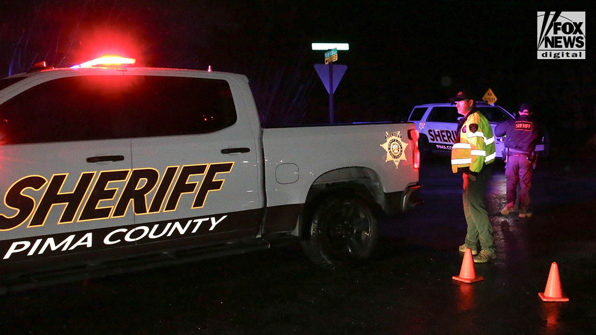 Pima County Sheriff's deputy standing at intersection during law enforcement operation in Tucson