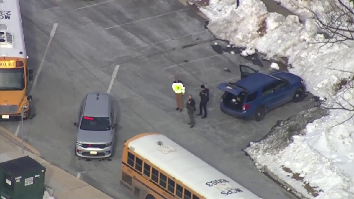 Aerial view of police vehicles and school buses outside a Maryland high school during a lockdown.
