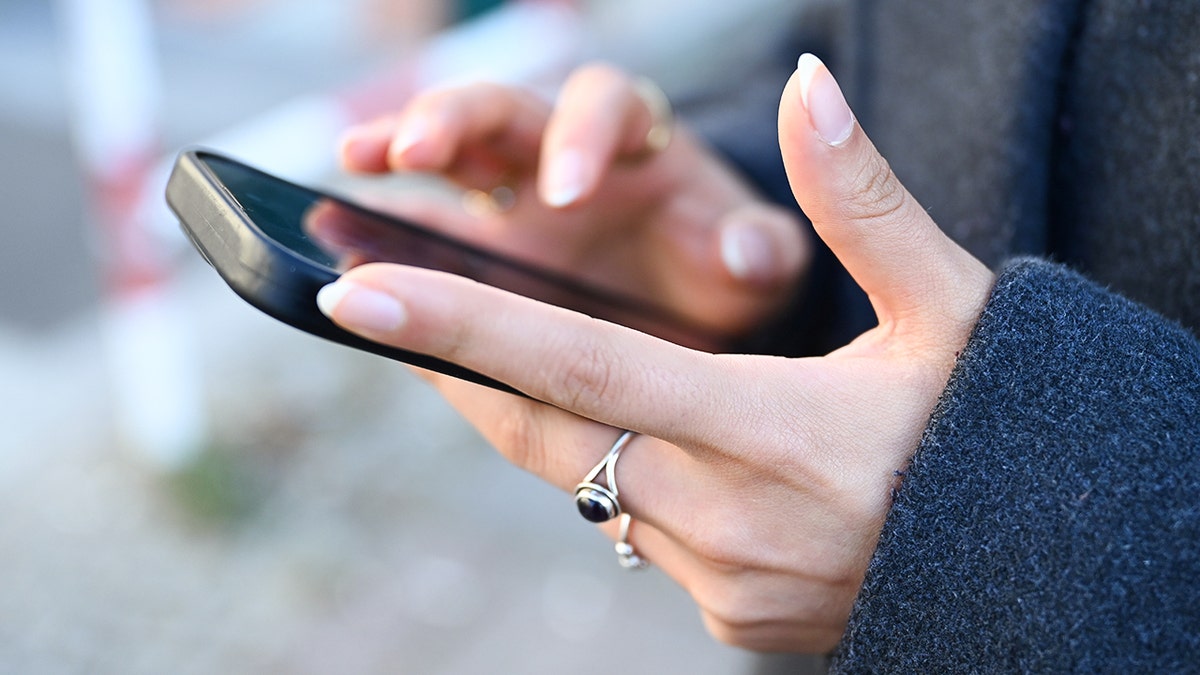 Woman typing connected  her smartphone.