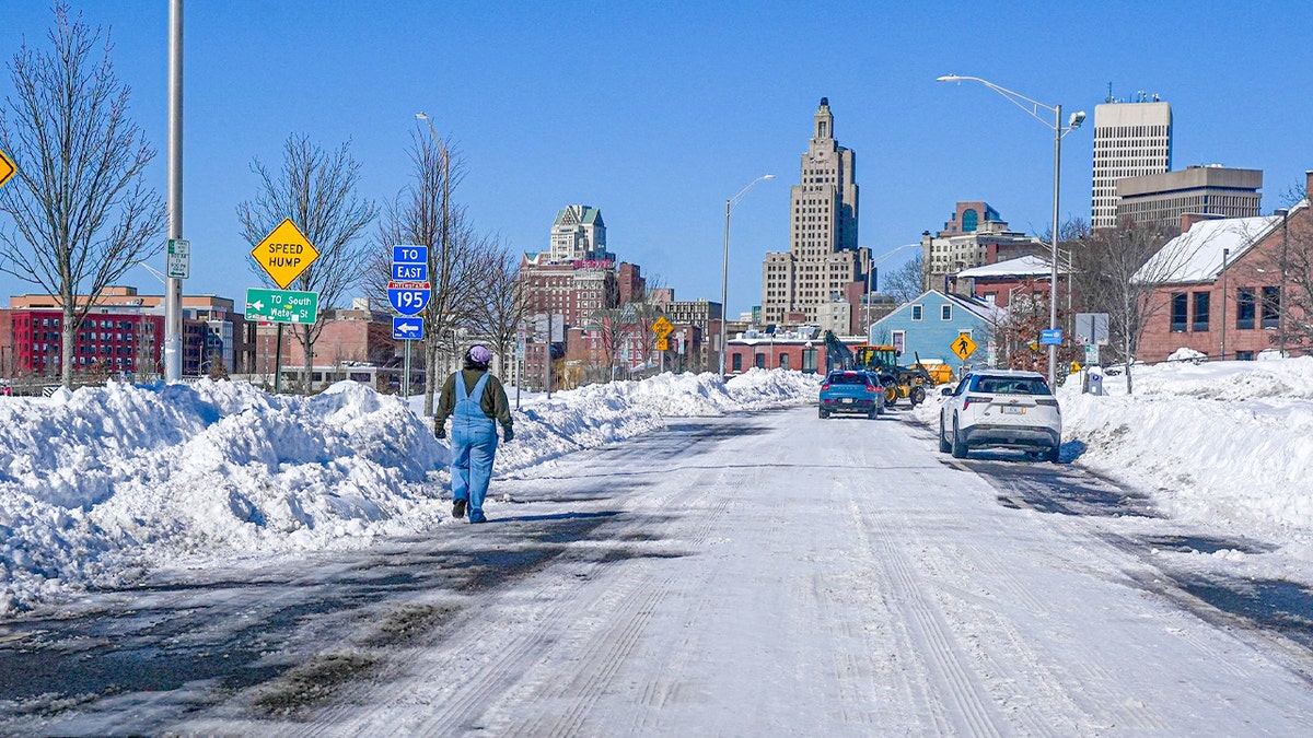 Snow blankets streets and sidewalks as crews and residents begin clearing heavy accumulation after a powerful blizzard.