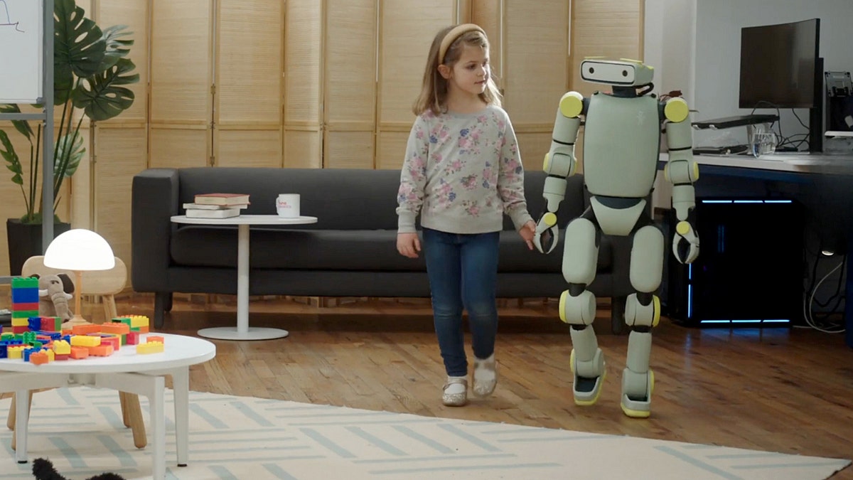 A child walking with a robot