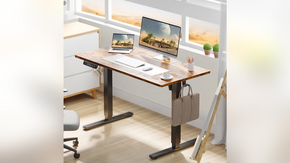 Stand and sit with the press of a button.