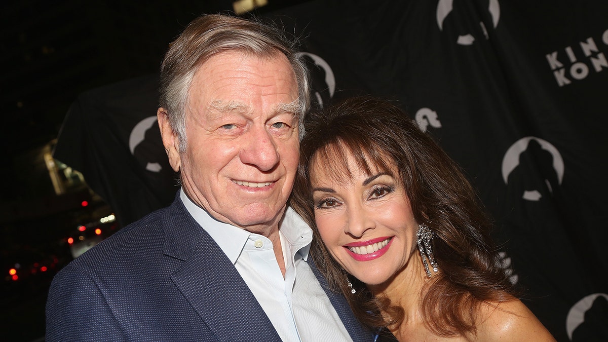 Susan Lucci leaning on her smiling husband Helmut Huber.
