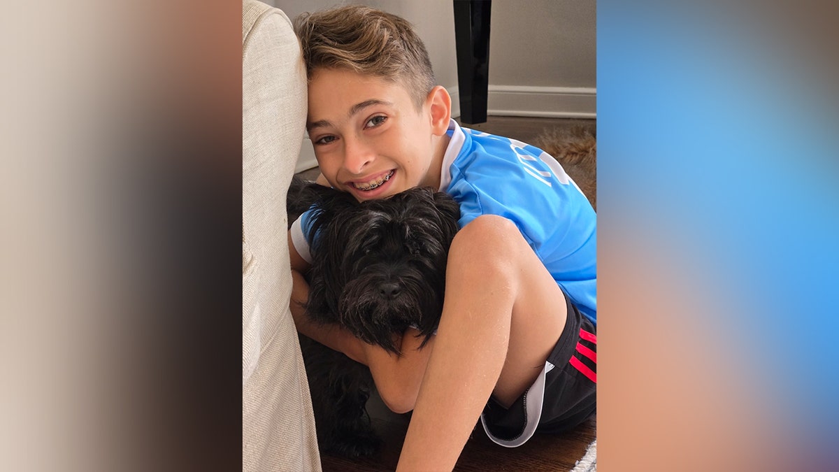 Thaddeus Giansanti with a black dog