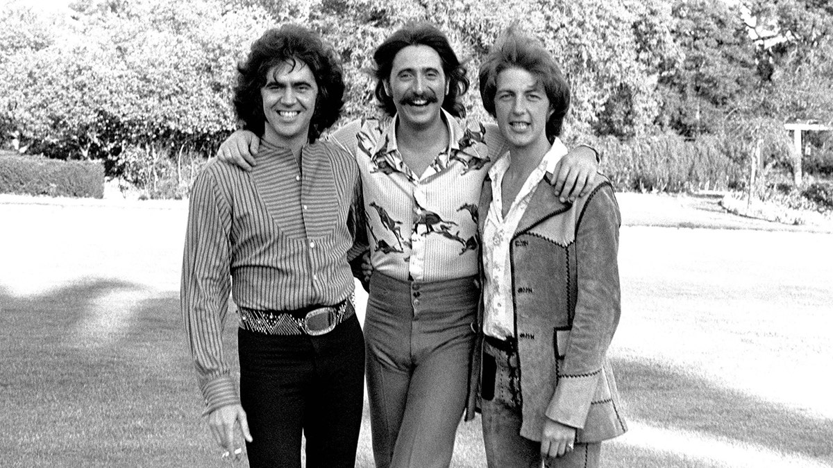 Three Dog Night posing and smiling