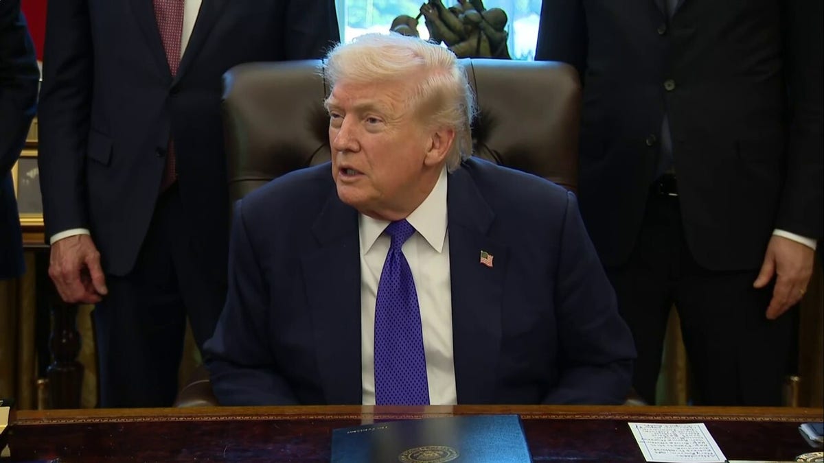 Donald Trump speaking to the press in the Oval Office.