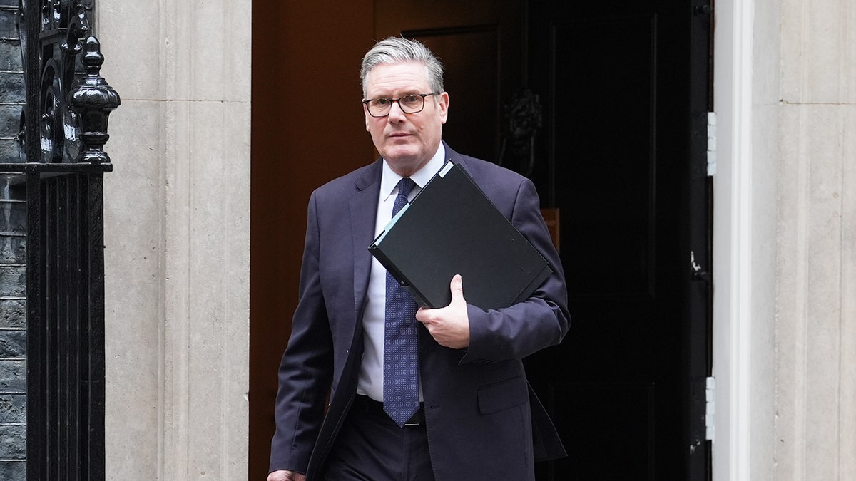 Sir Keir Starmer departing Downing Street holding a binder.