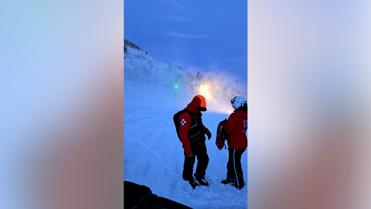search and rescuers on snowy mountain