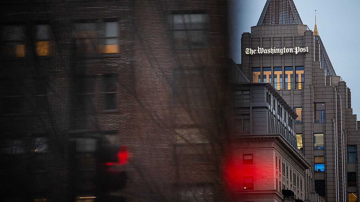 The Washington Post sign above a building at twilight