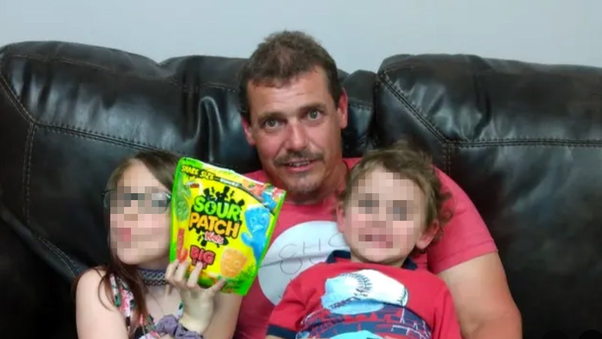 William Palmer and two children with blurred faces