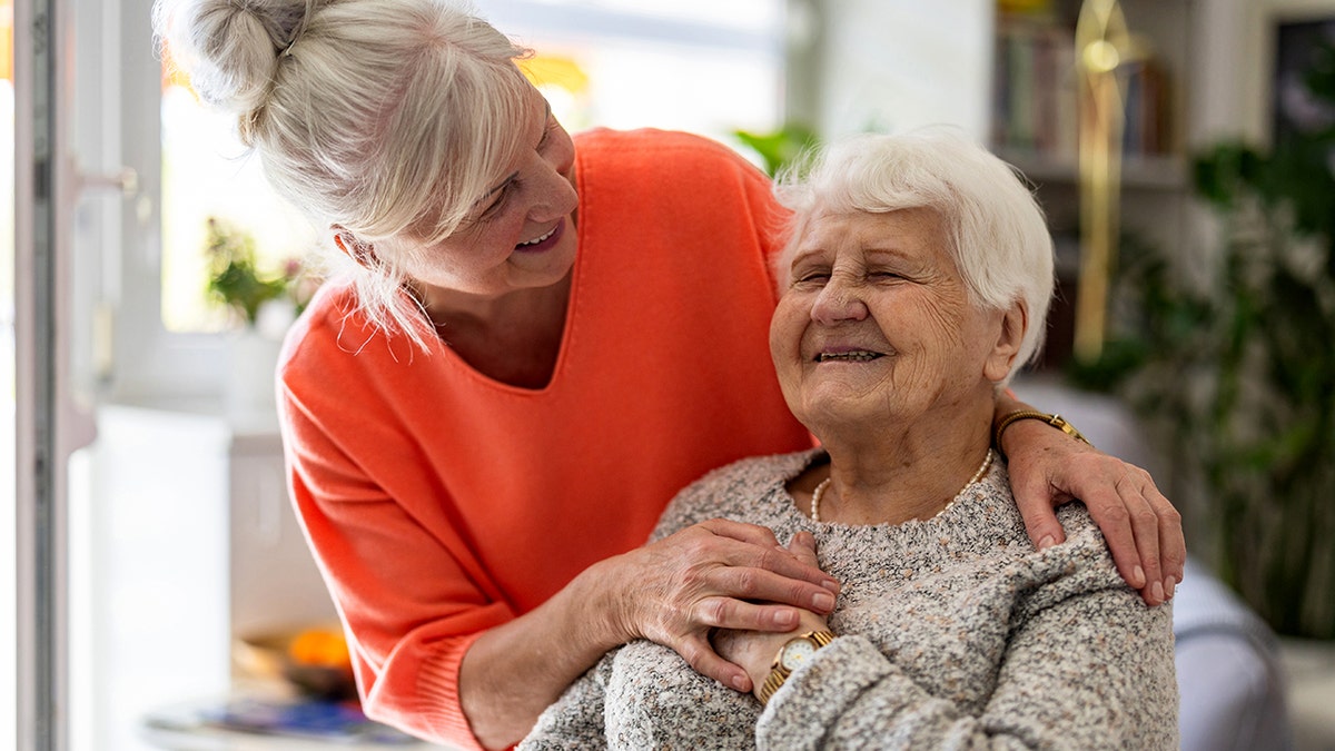 Female home caregiver providing emotional support to an elderly woman