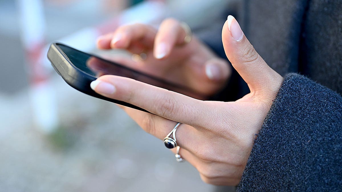 Woman typing on phone.