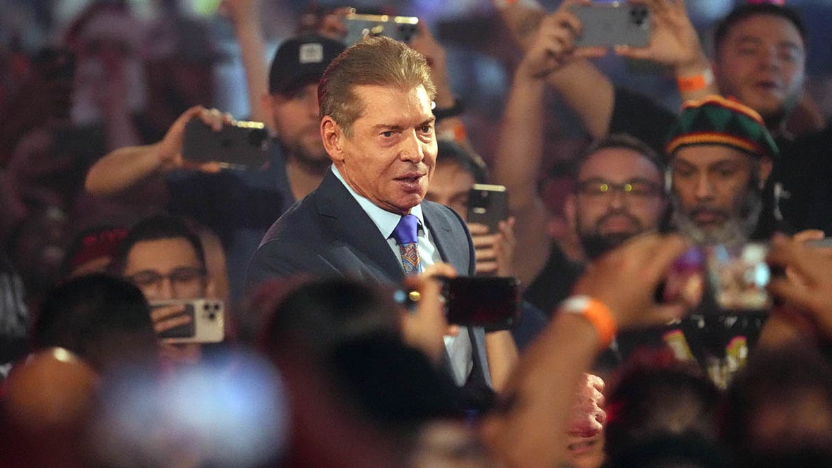 Vince McMahon enters an arena for a WWE event
