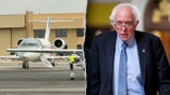 Sen. Bernie Sanders, I-Vt., next to private jet