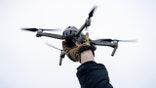 A man holds a drone in his hand before launching it during a military exercise on March 23, 2024 in Kyiv, Ukraine. On 24 February 2022, Russia invaded Ukraine in an escalation of the Russian-Ukrainian War that started in 2014.