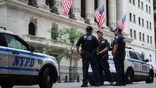 New York Police Department officers stand on duty in front of the New York Stock Exchange in New York City.