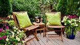 Sheltered outdoor garden patio oasis for afternoon backyard relaxation and glass of wine on warm seasonal summer days
