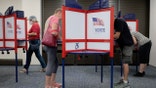 Residents participate in the start of early voting at a Henrico polling site ahead of Virginia’s statewide elections.