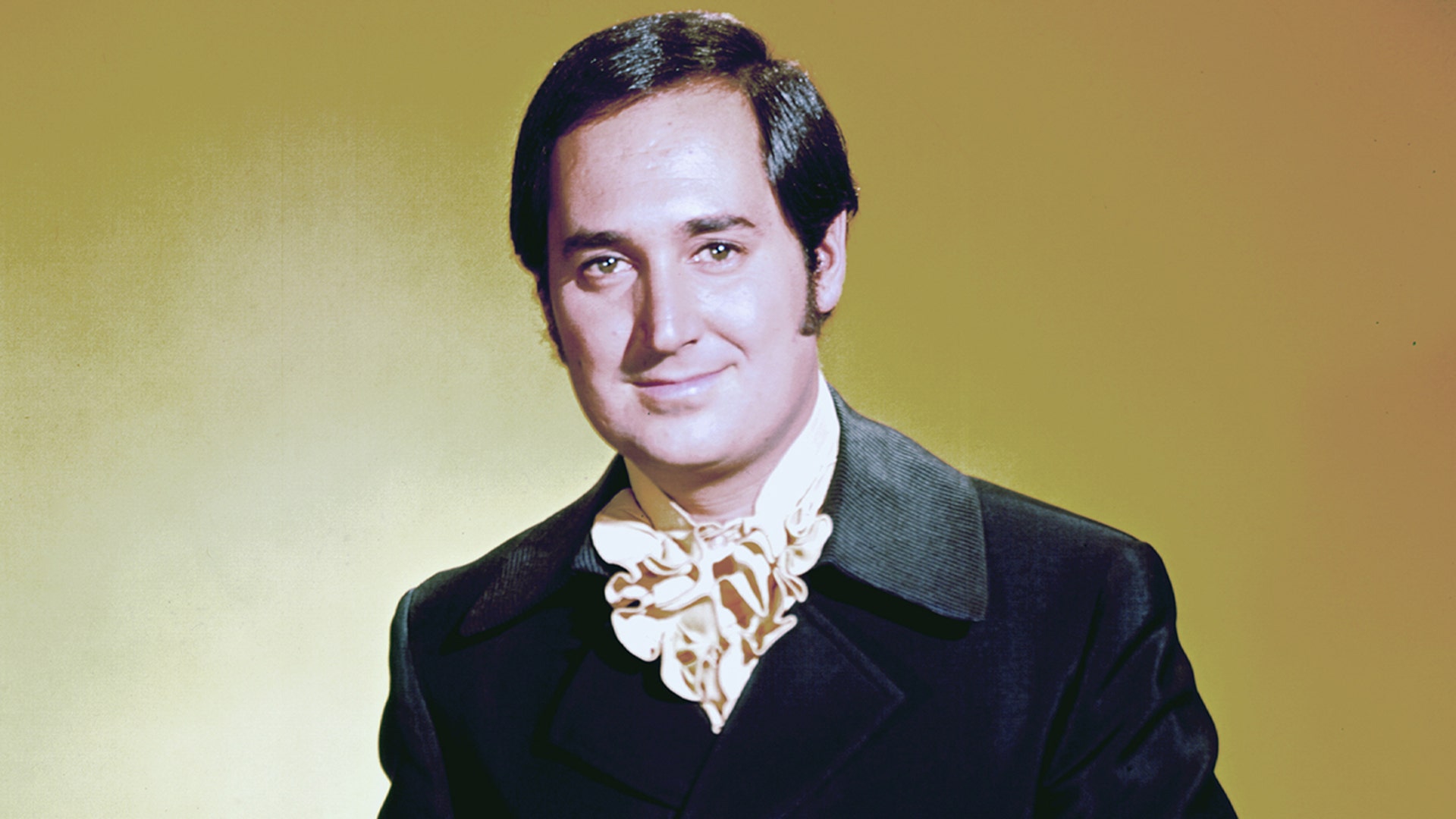 Neil Sedaka posing for a photo in the 1960s.