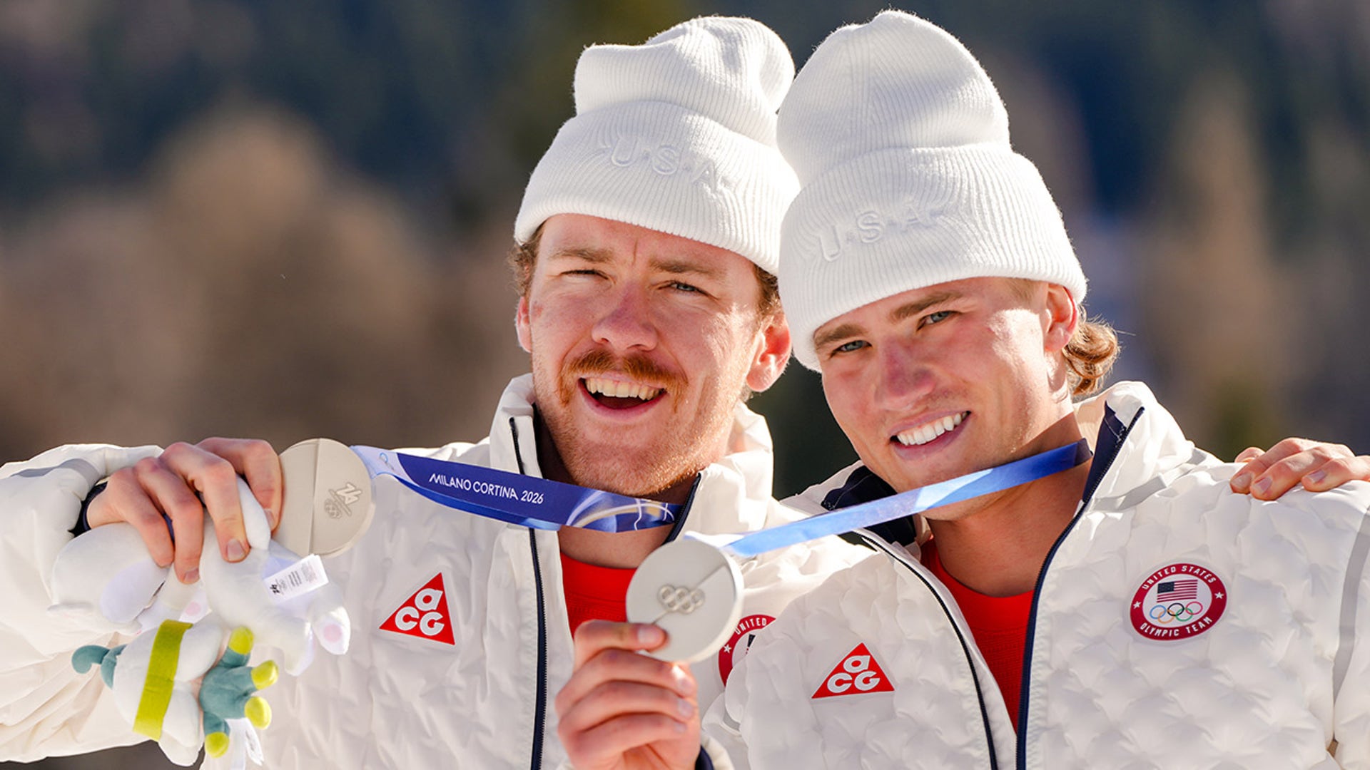 Ben Ogden and Gus Schumacher pose with their medals
