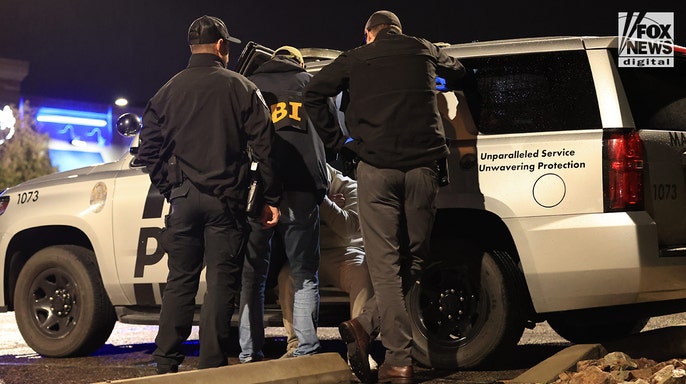 A man being detained by law enforcement during a traffic stop in Tucson, Arizona.