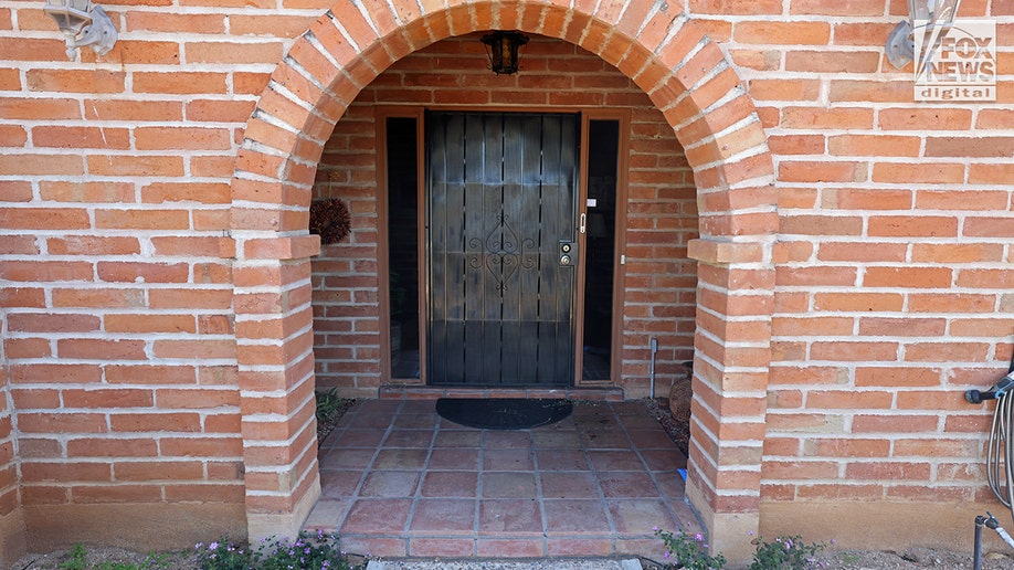 Exterior of Nancy Guthrie's house in Tucson, Arizona, showing several red droplets.