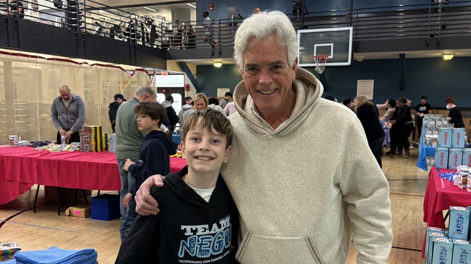 Nathan Hoffman and Fox News anchor John Roberts at a Joy Jar event.