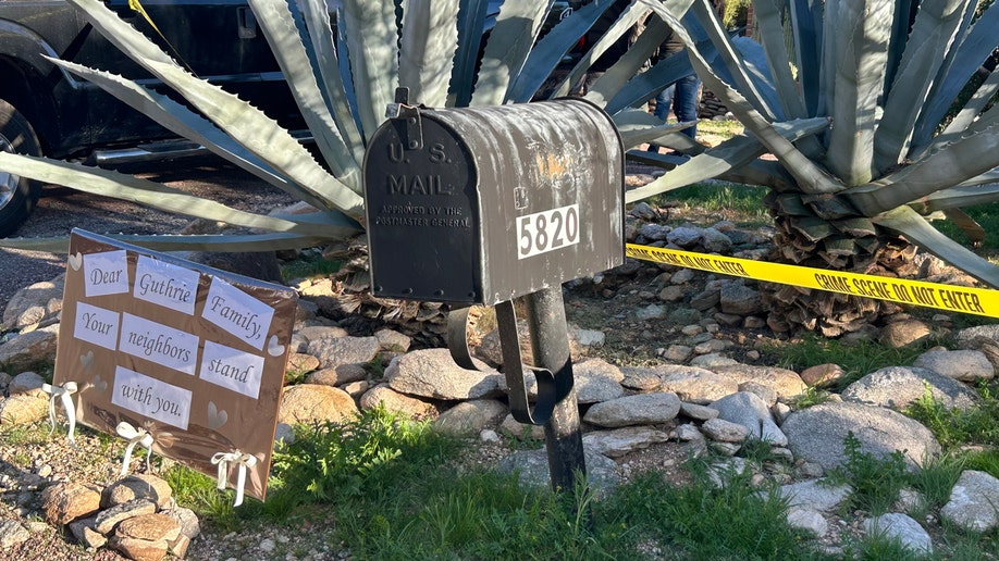 A motion   successful  beforehand   of a mailbox with transgression  country   portion    astir   a home.