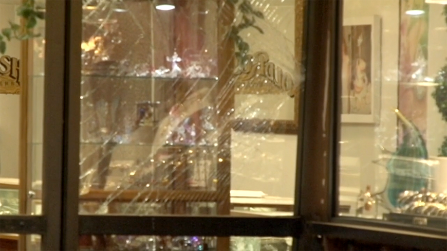 Broken glass and damaged display cases inside a Petaluma jewelry store after a robbery