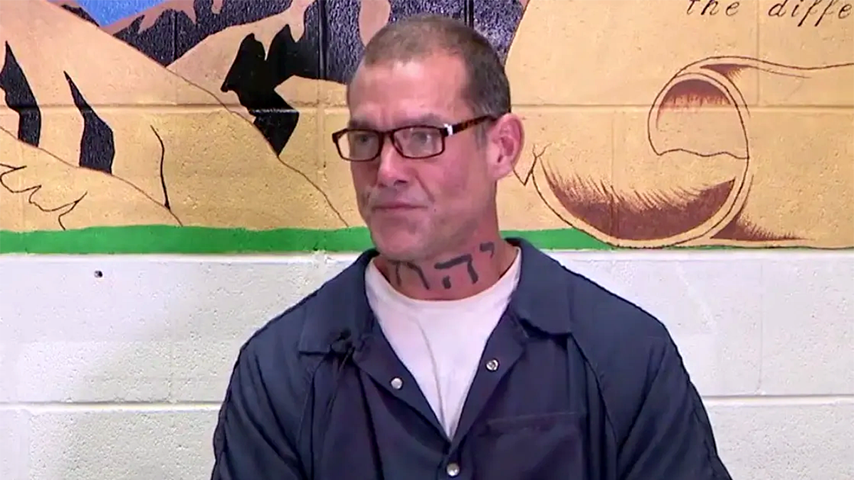 Adam sheafe successful bluish jailhouse jumpsuit and glassess