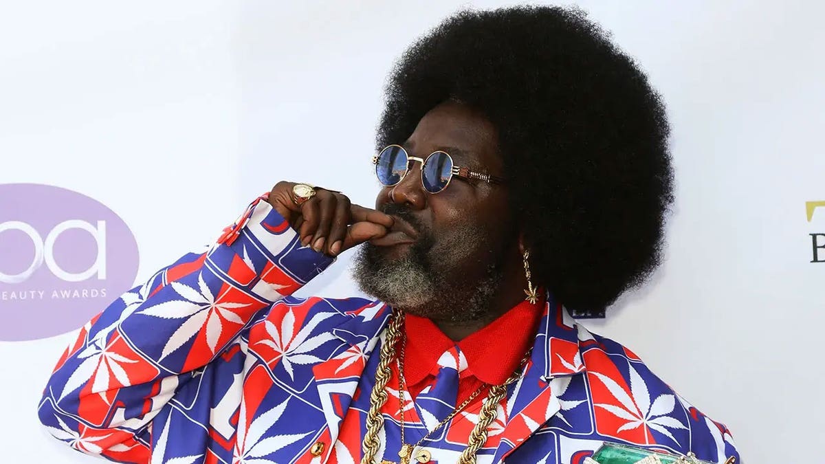 Rapper 'Afroman' makes hand signal for smoking weed