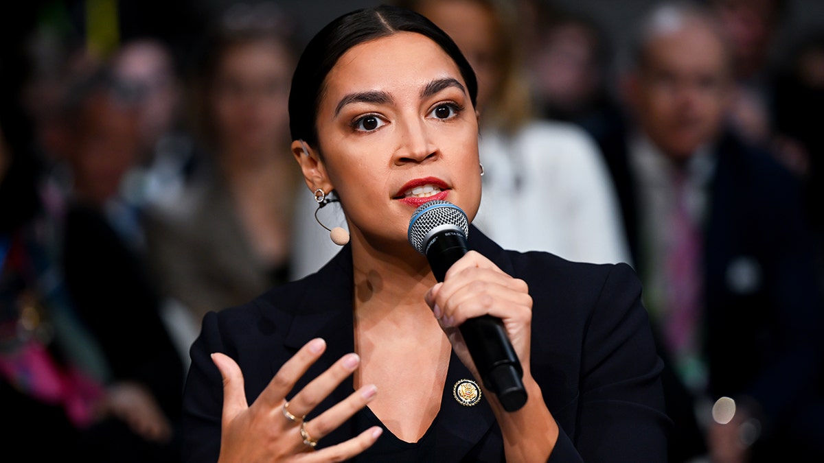 Rep. Alexandria Ocasio-Cortez speaks with microphone