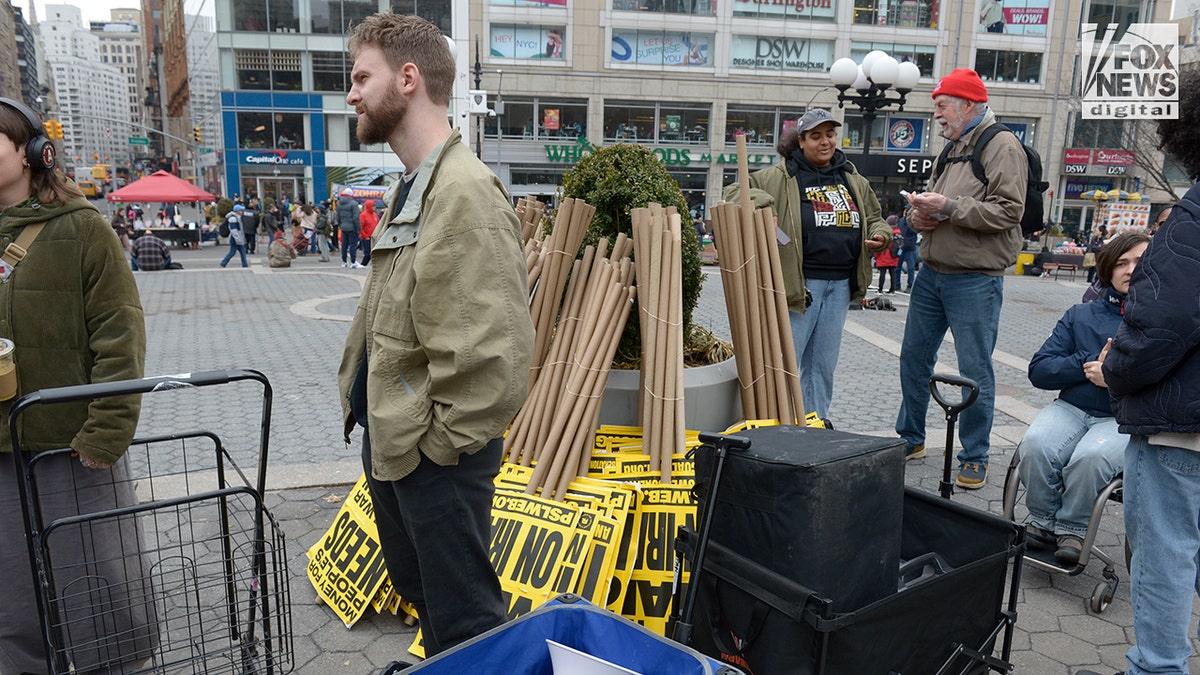 Los miembros de la Coalición ANSWER están colocando pancartas y carteles en Union Square.